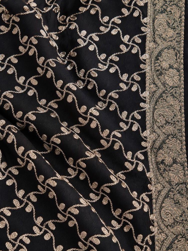 Black winter shawl with intricate gold-toned embroidery, ornate patterned borders and decorative tassels