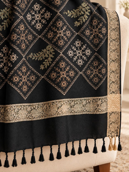 Black shawl for women featuring diamond-shaped floral embroidery, antique-gold patterned borders and black tassels.