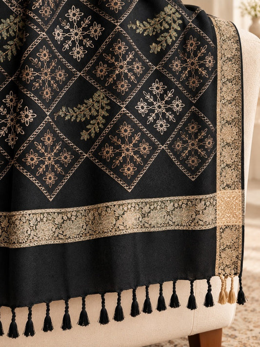 Black shawl for women featuring diamond-shaped floral embroidery, antique-gold patterned borders and black tassels.