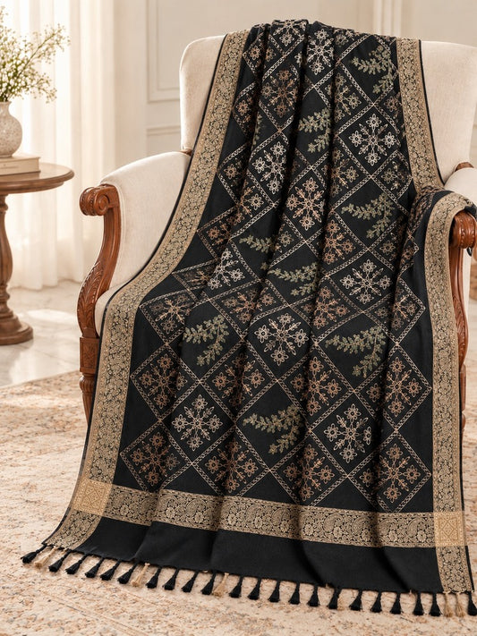 Black shawl for women featuring diamond-shaped floral embroidery, antique-gold patterned borders and black tassels.