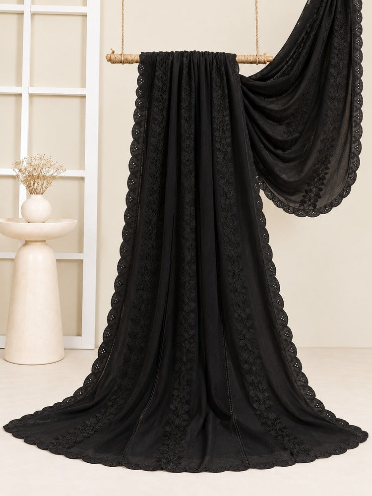 Black embroidered shawl for women featuring intricate floral embroidery, a scalloped lace border, and an elegant draped design
