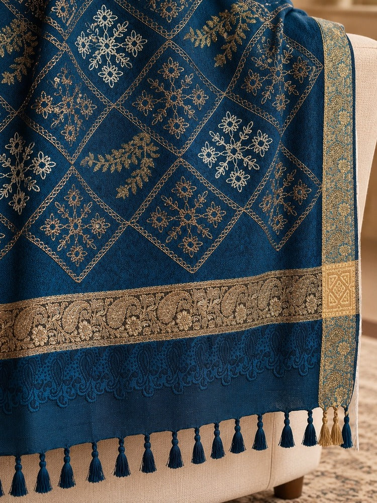 winter wrap with multicoloured floral diamond embroidery, ornate beige-gold borders and decorative tassels.