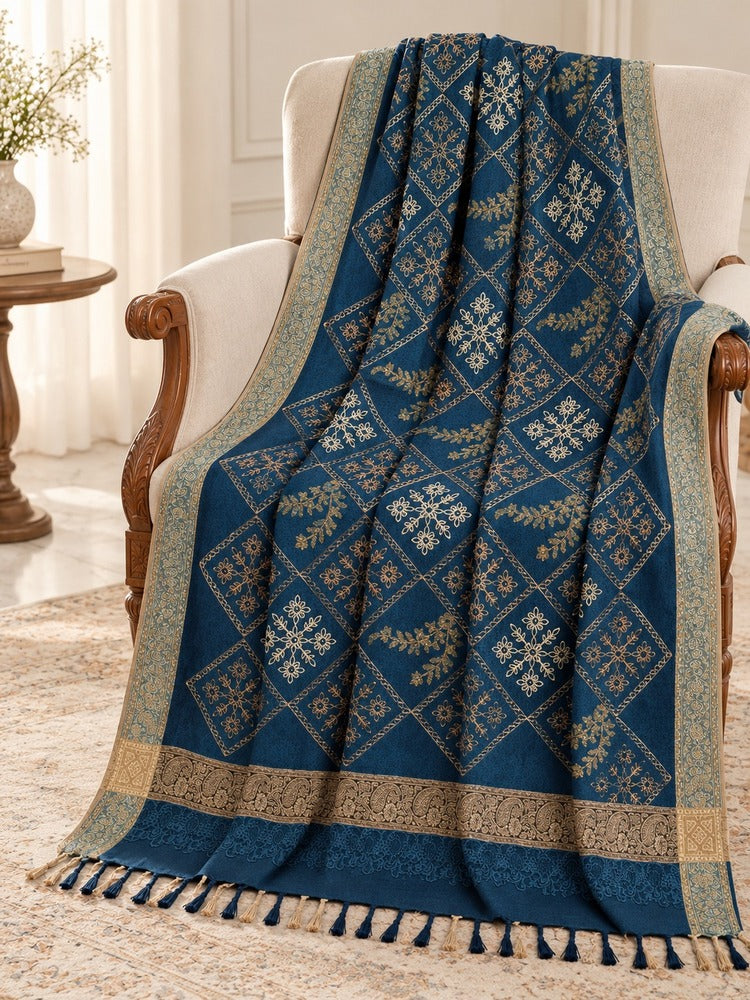 winter wrap with multicoloured floral diamond embroidery, ornate beige-gold borders and decorative tassels.