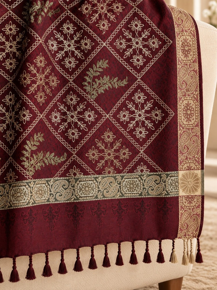Maroon embroidered winter shawl with diamond-shaped floral motifs, olive-gold detailing, ornate borders and tassel edging.