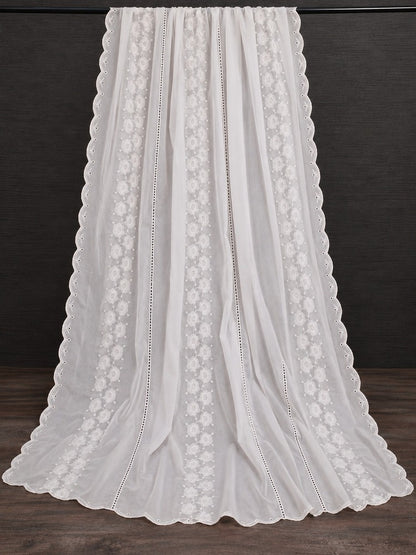 White shawl for women with delicate floral embroidery and scalloped lace edges on a dark background.